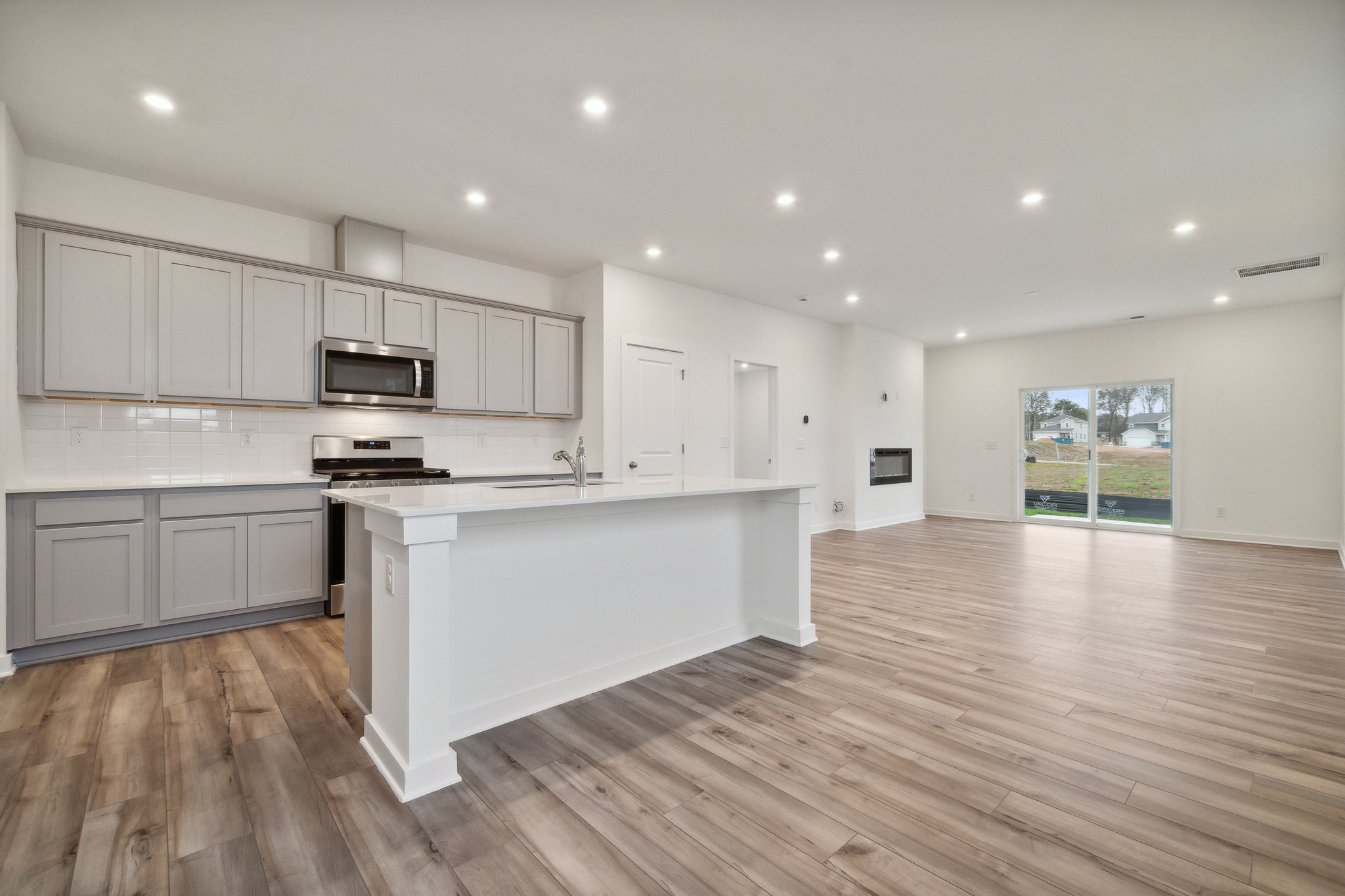 A kitchen with white cabinets.