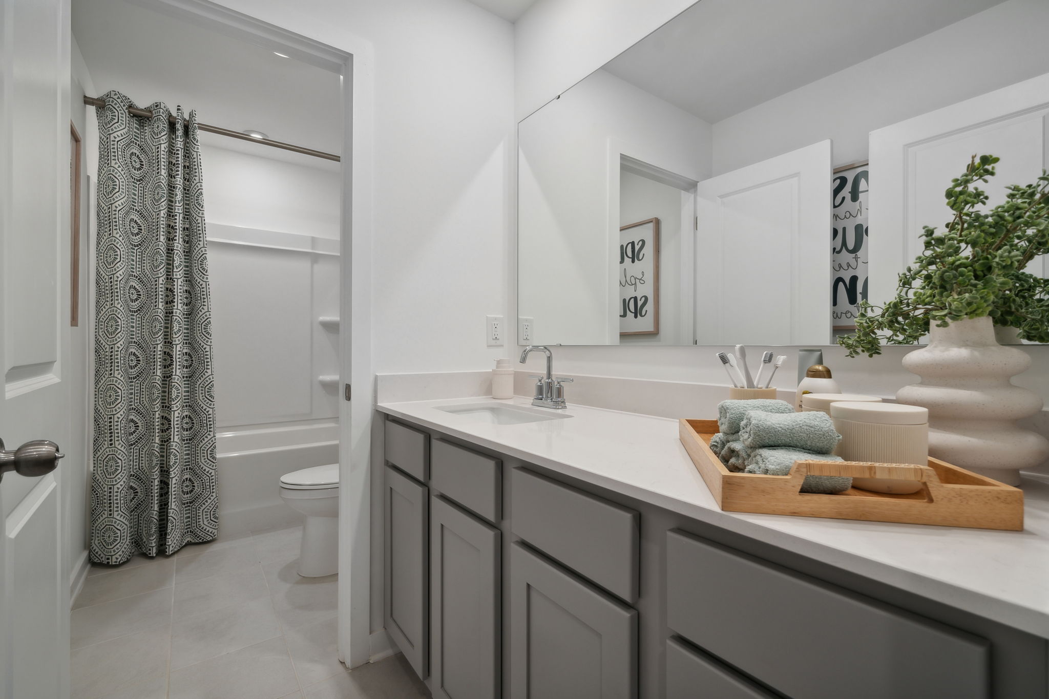 A bathroom with a tub sink and toilet.