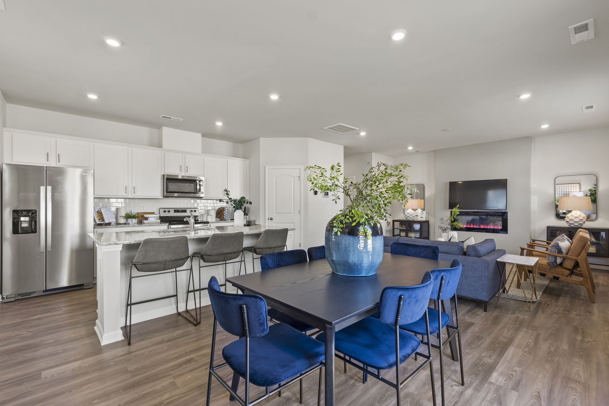 A kitchen with a table and chairs.