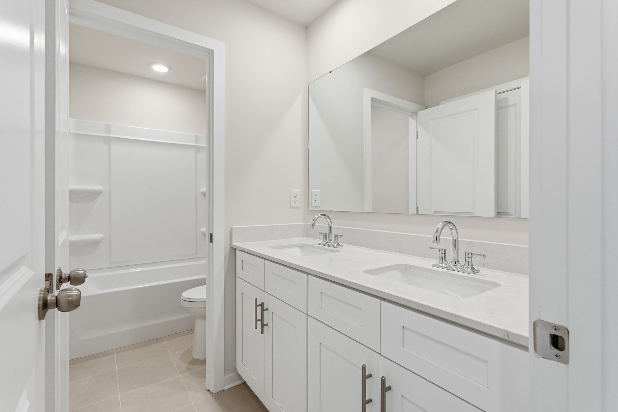 A bathroom with a sink toilet and shower.