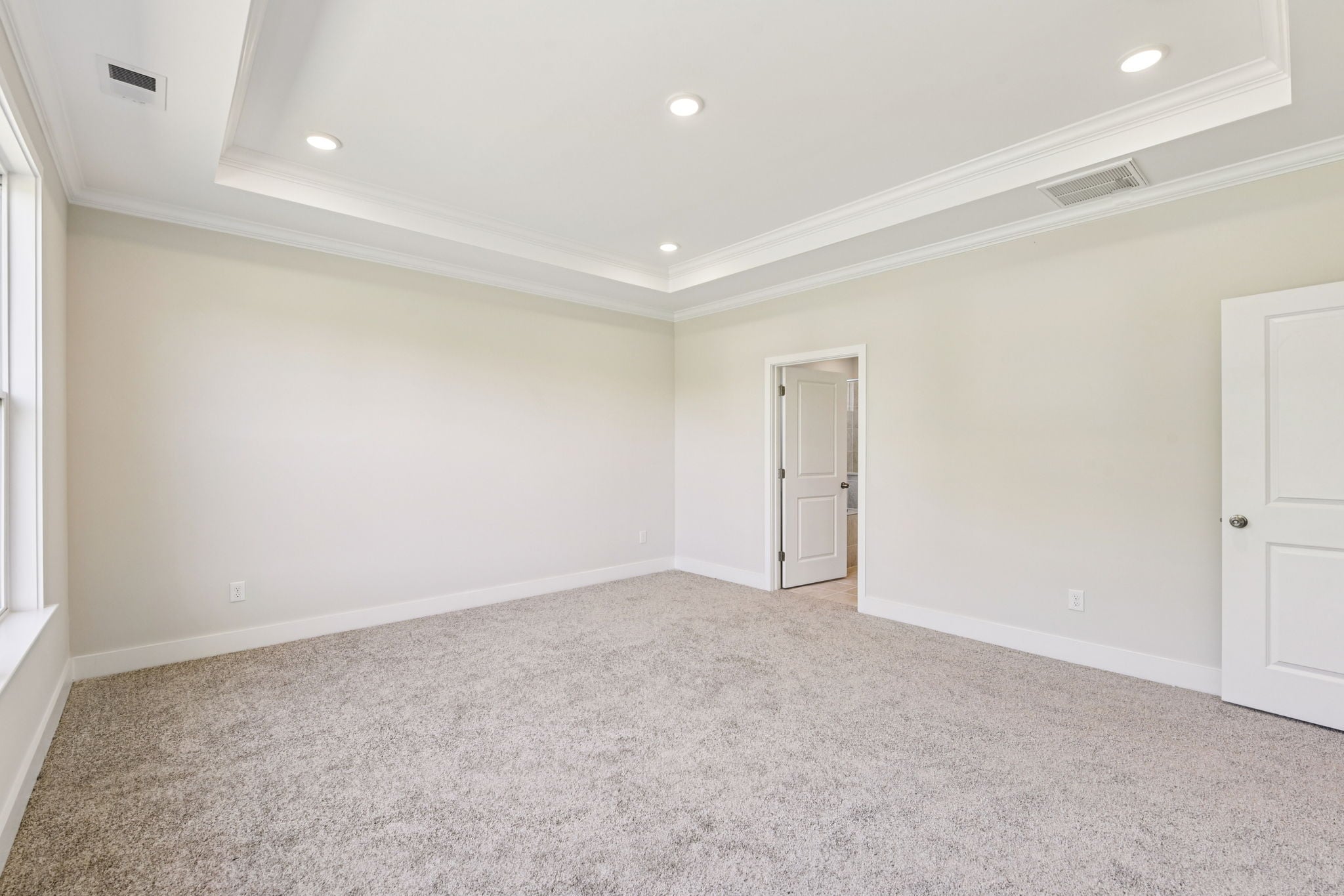 A room with white walls and a carpeted floor.