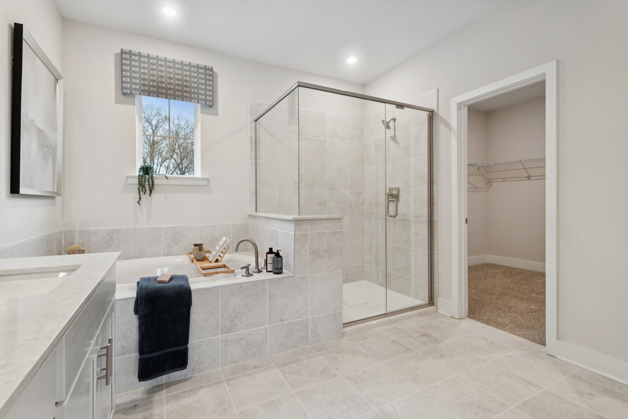 A bathroom with a shower and sink.