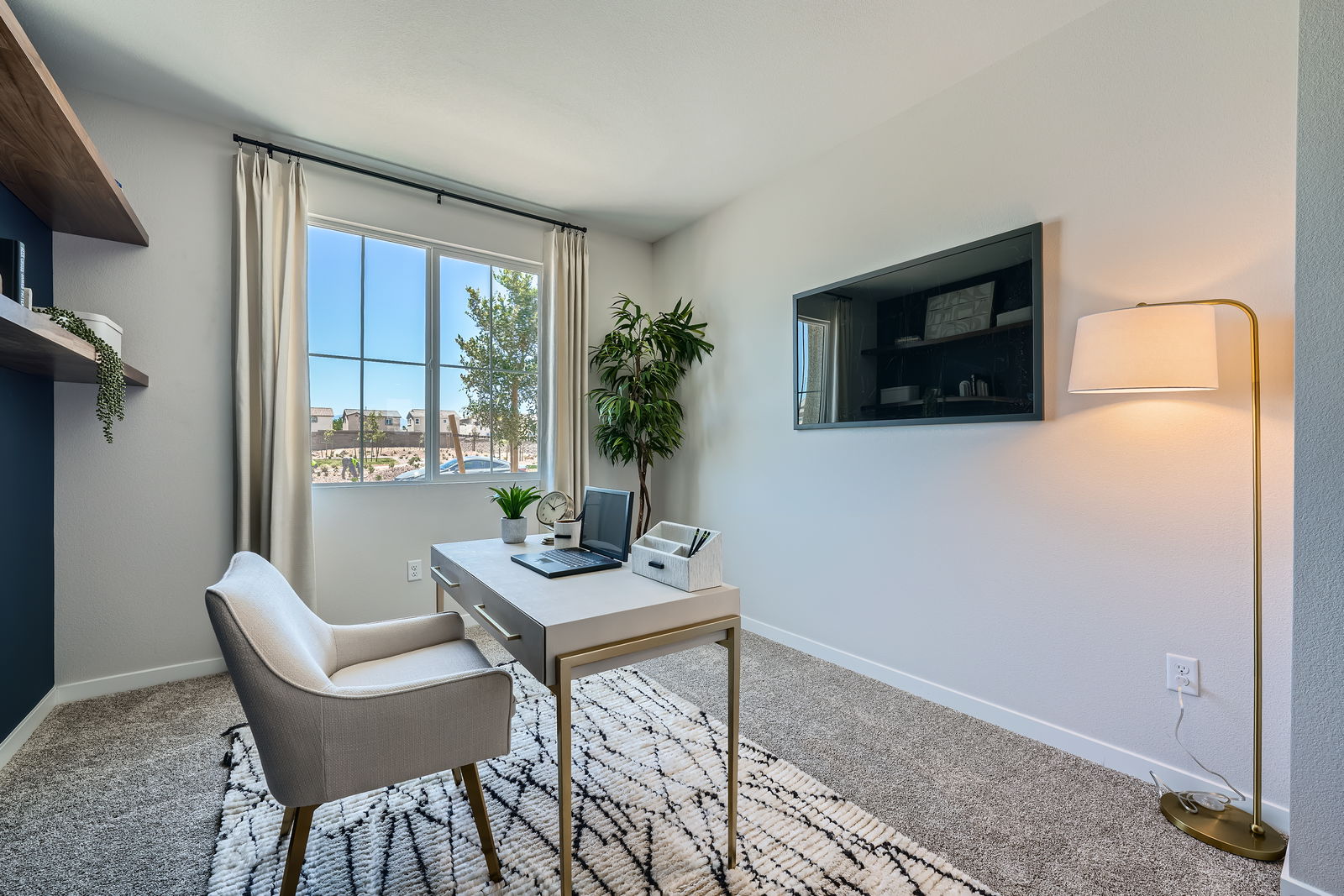 A room with a desk and a chair.