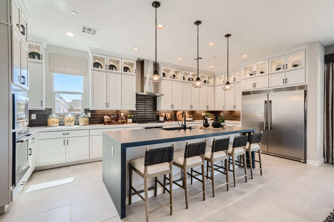 A kitchen with a bar and island.