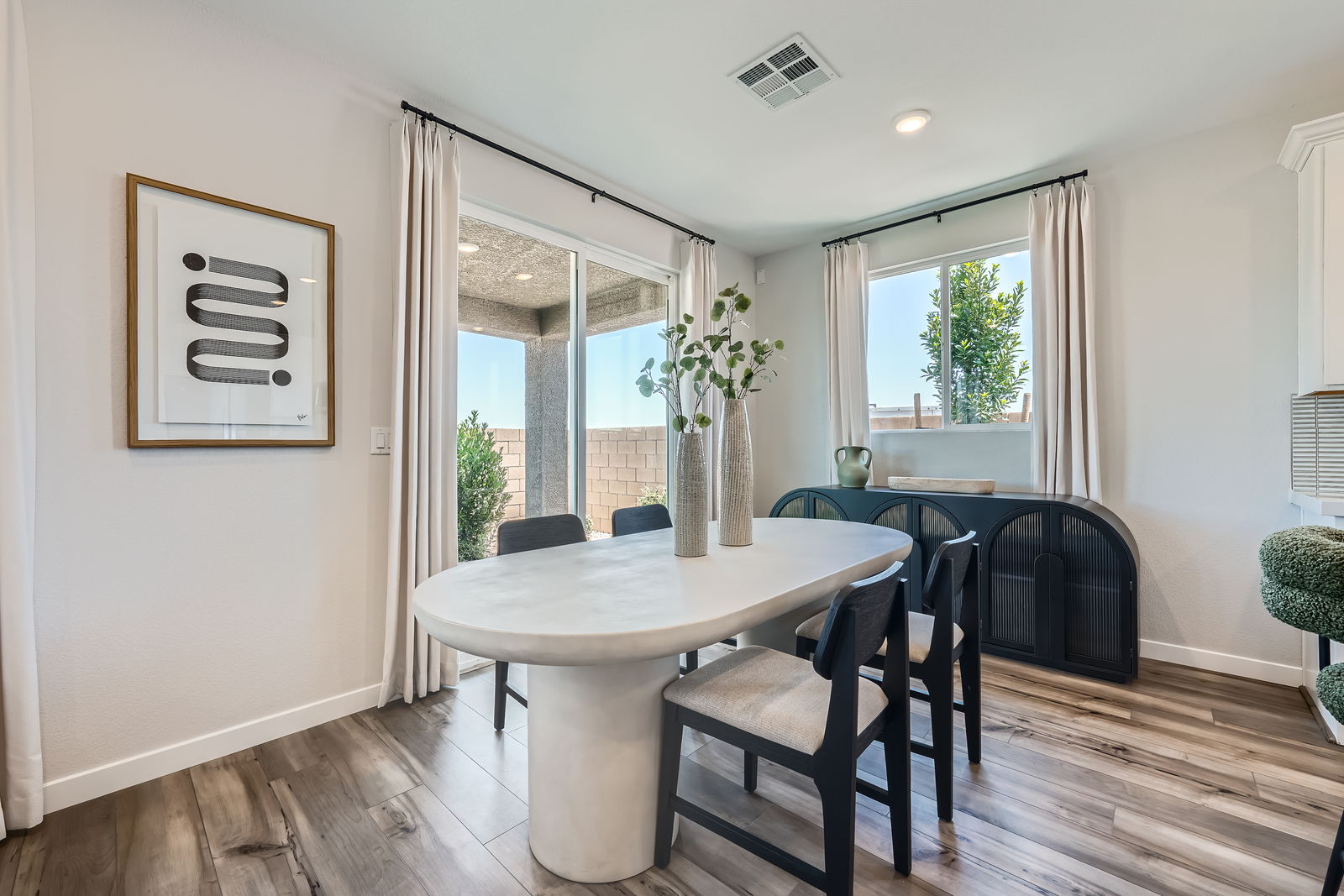 A dining room with a table and chairs.