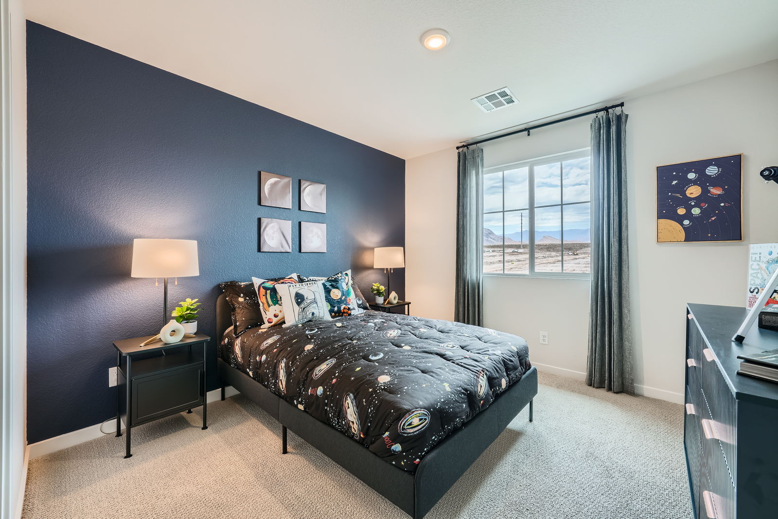 A bedroom with a bed and a desk.