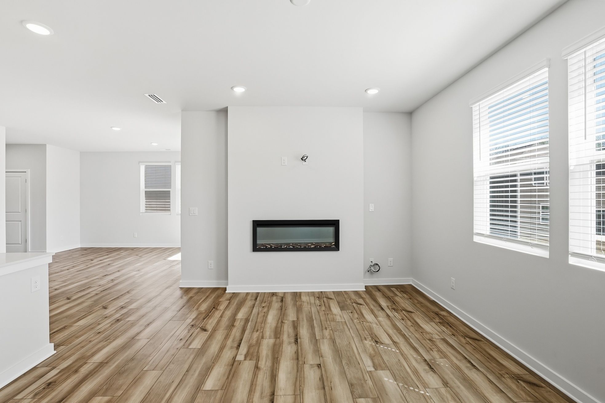 A room with a wood floor and white walls.