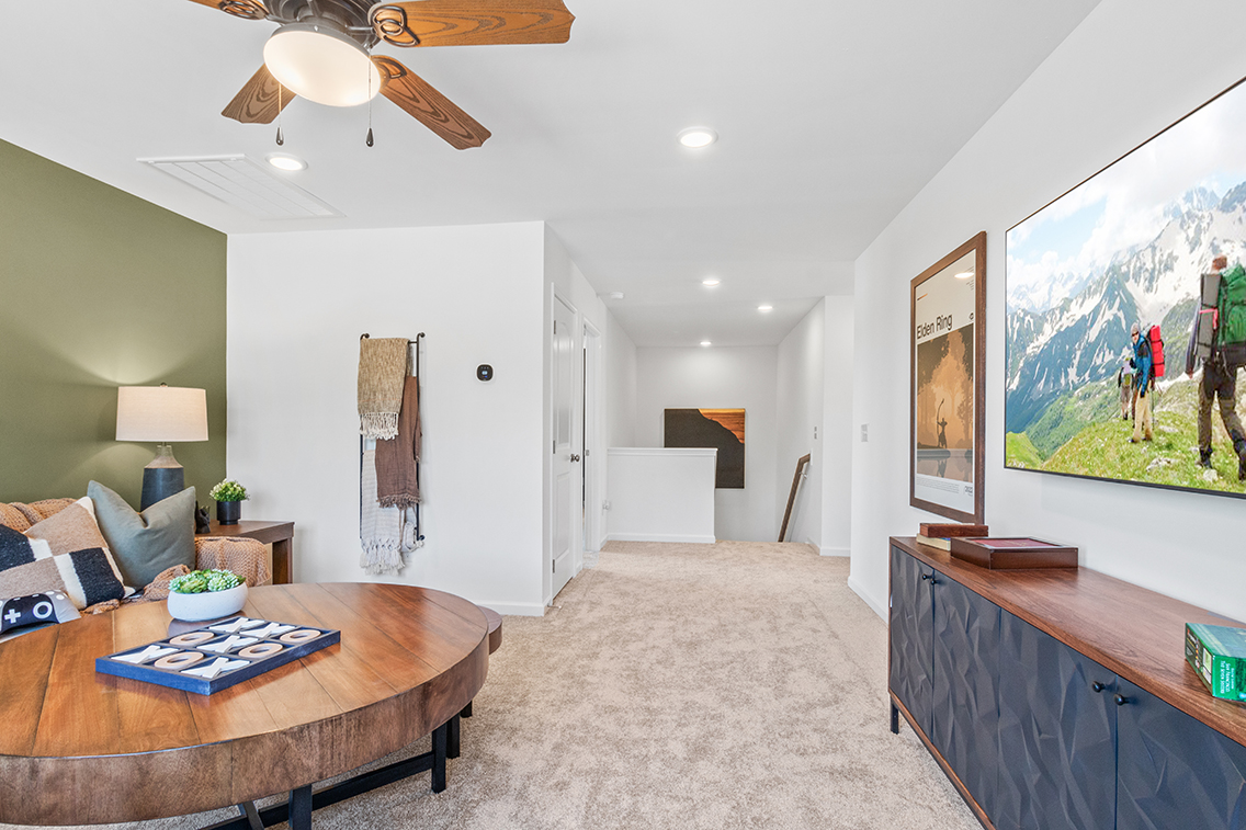 A living room with a large painting.