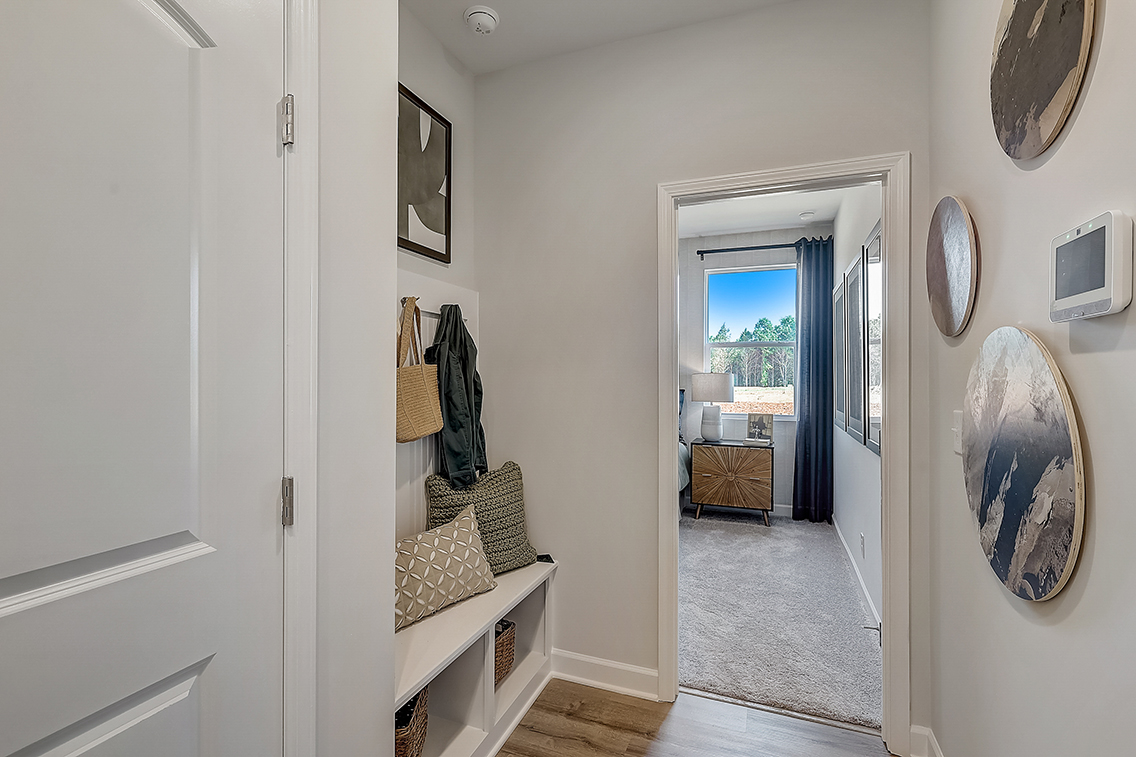 A room with a bed and a mirror.