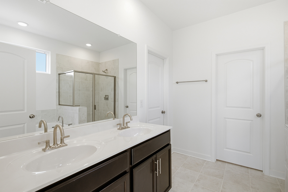 A bathroom with a large mirror.