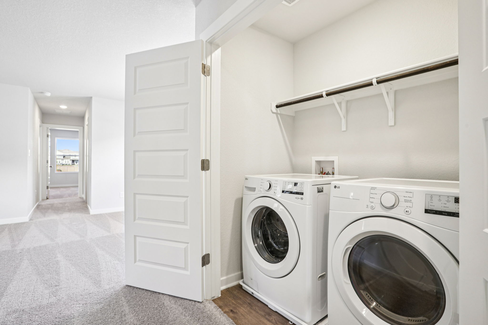 A room with a washing machine and a dryer.