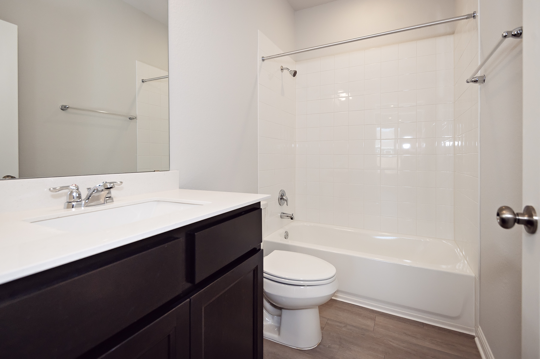 A bathroom with a tub sink and toilet.