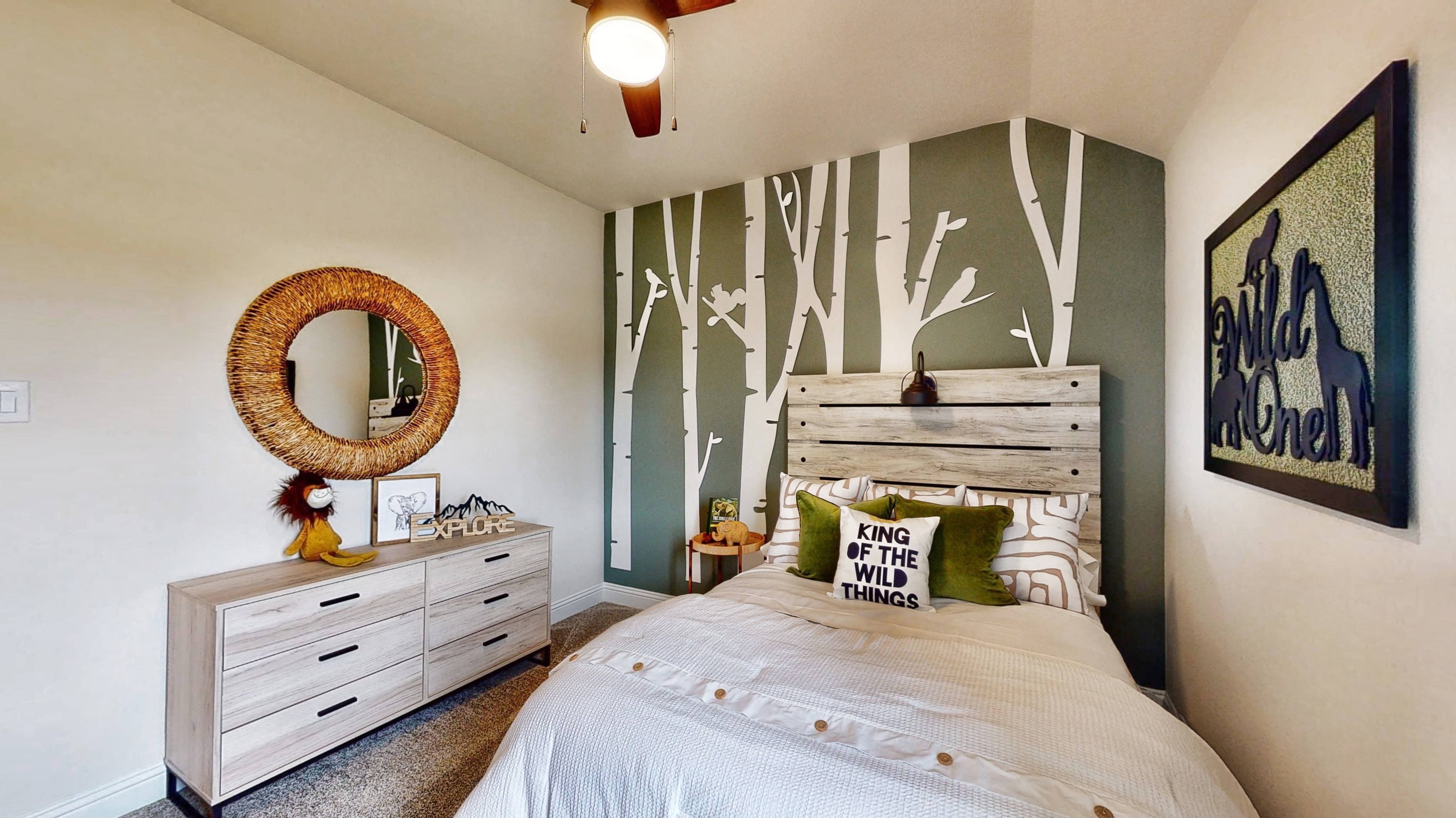 A bedroom with a bed and dresser.