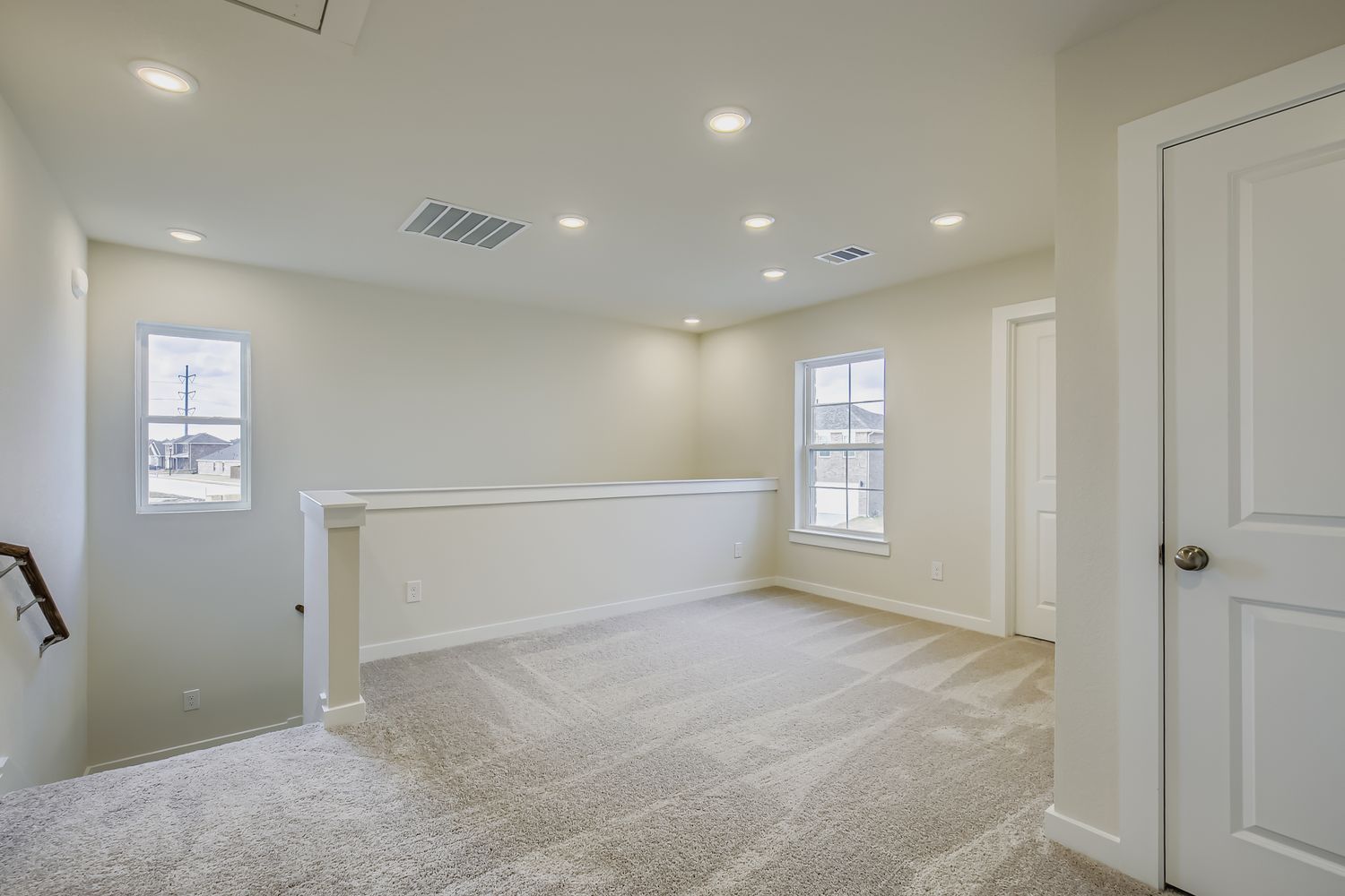 A room with white walls and a white bench.