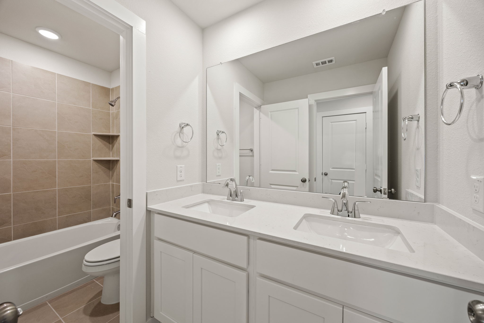 A bathroom with a tub sink and toilet.