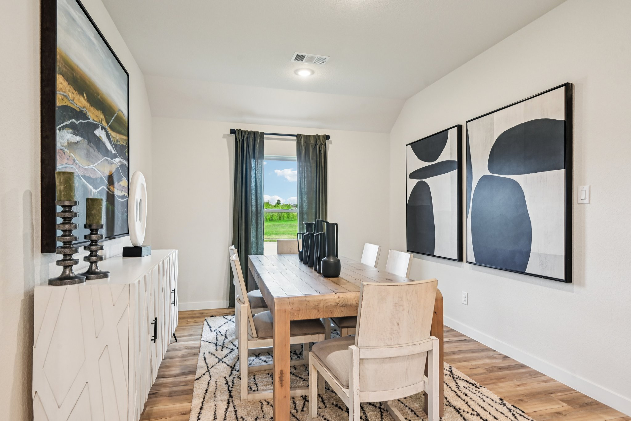 A dining room with a large window.