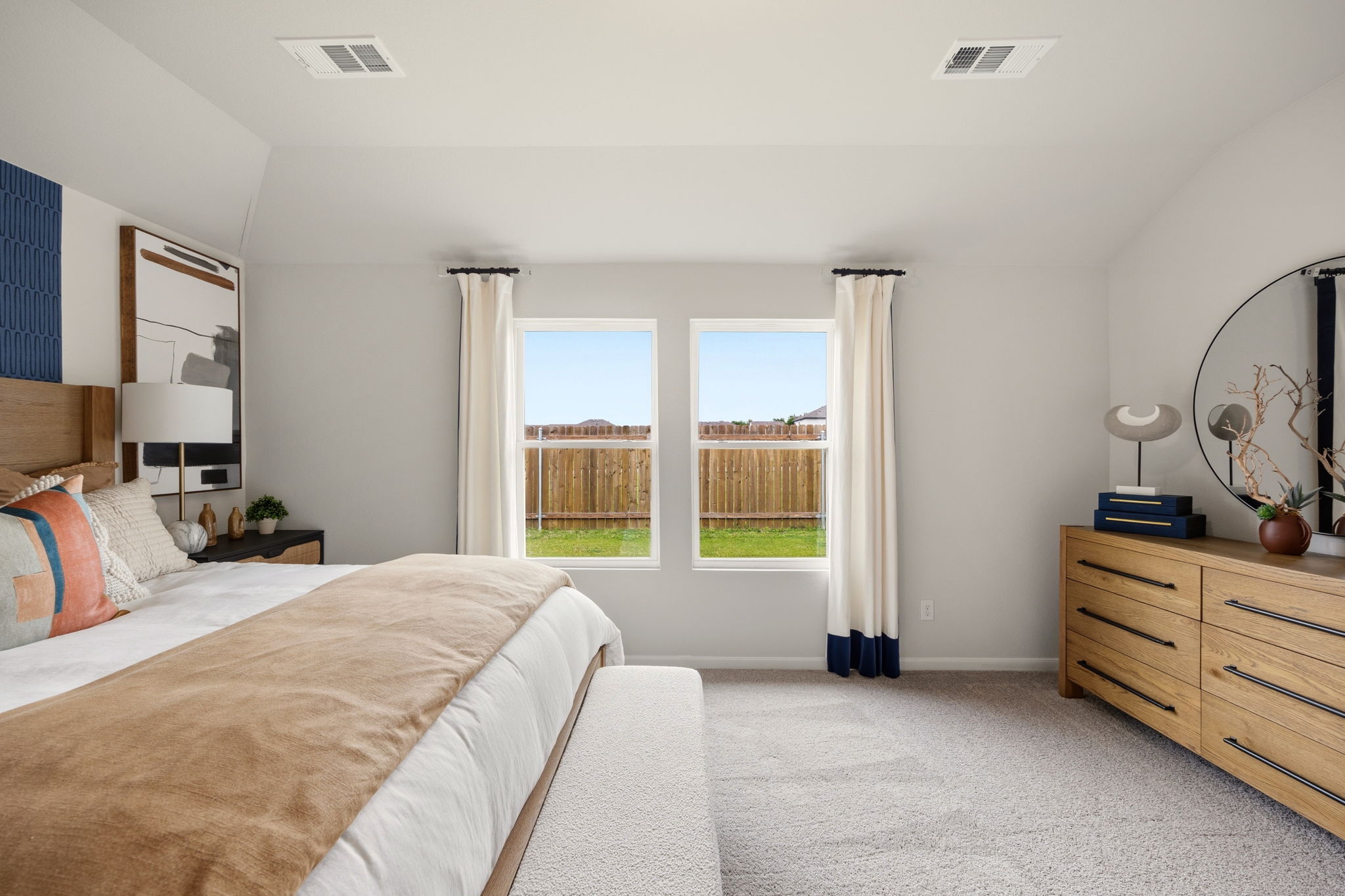 A bedroom with a large window.