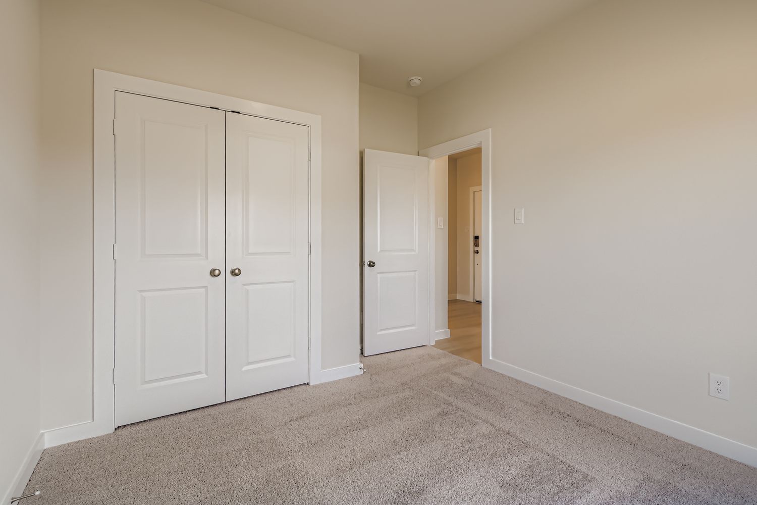 A hallway with white doors.