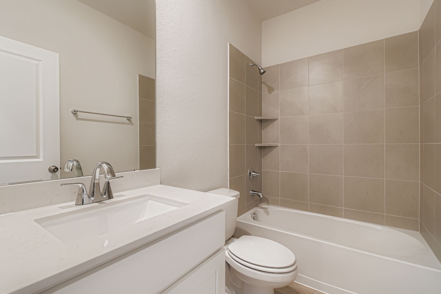 A bathroom with a tub sink and toilet.