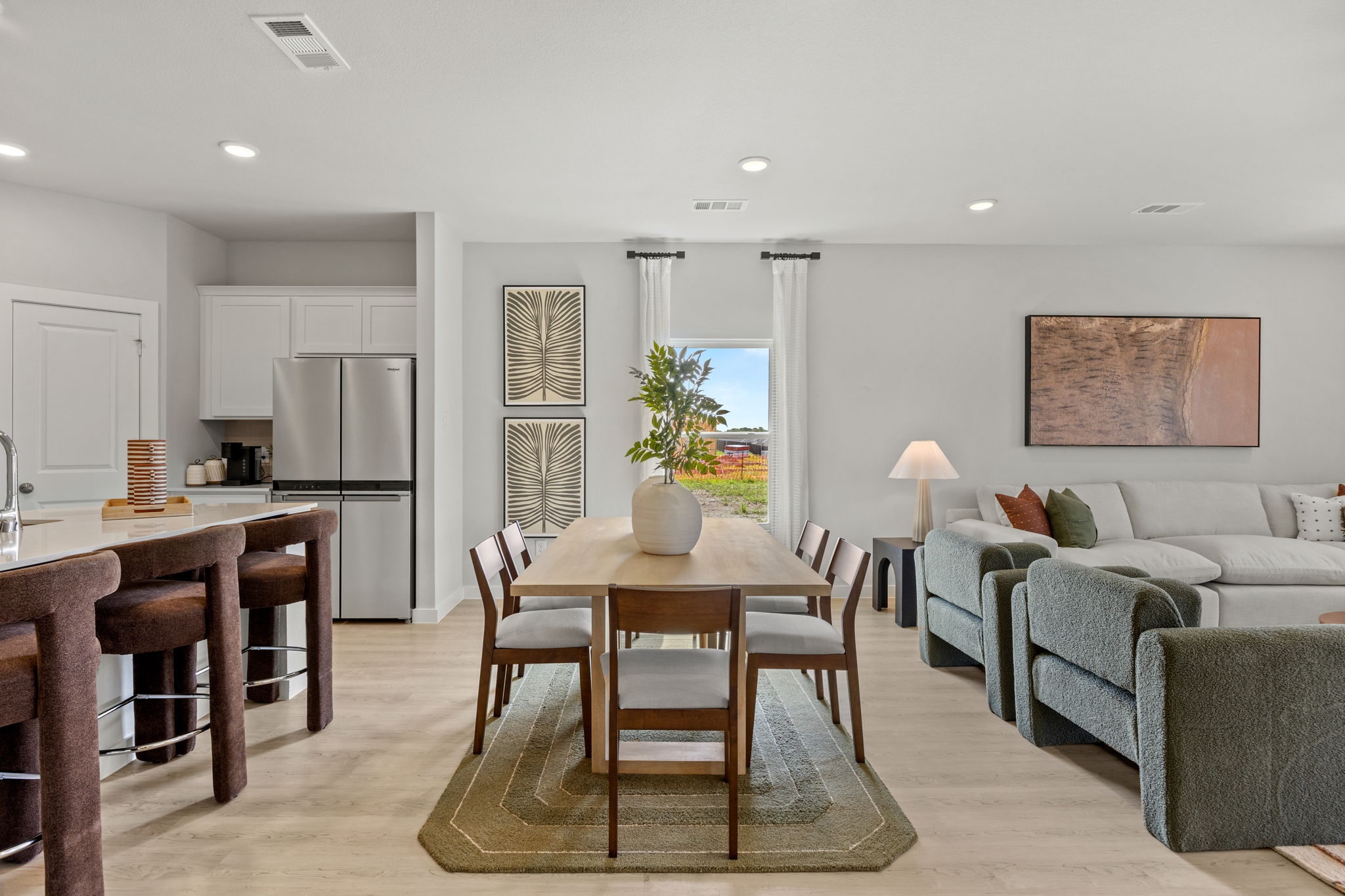 A large living room with a dining table and chairs.