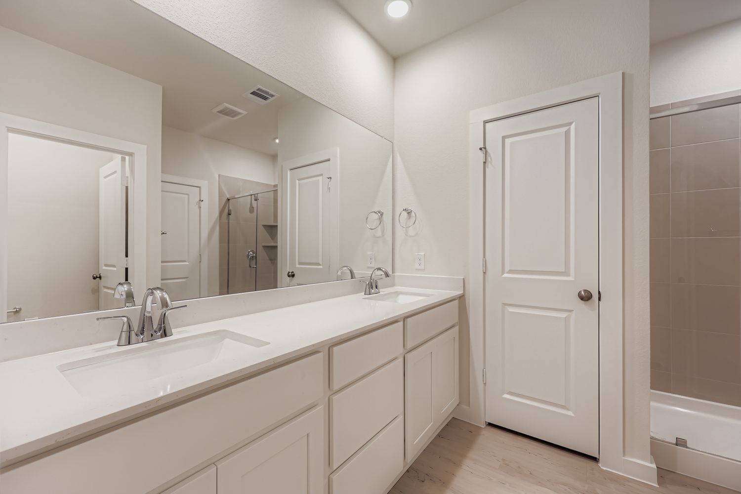 A bathroom with a large mirror.