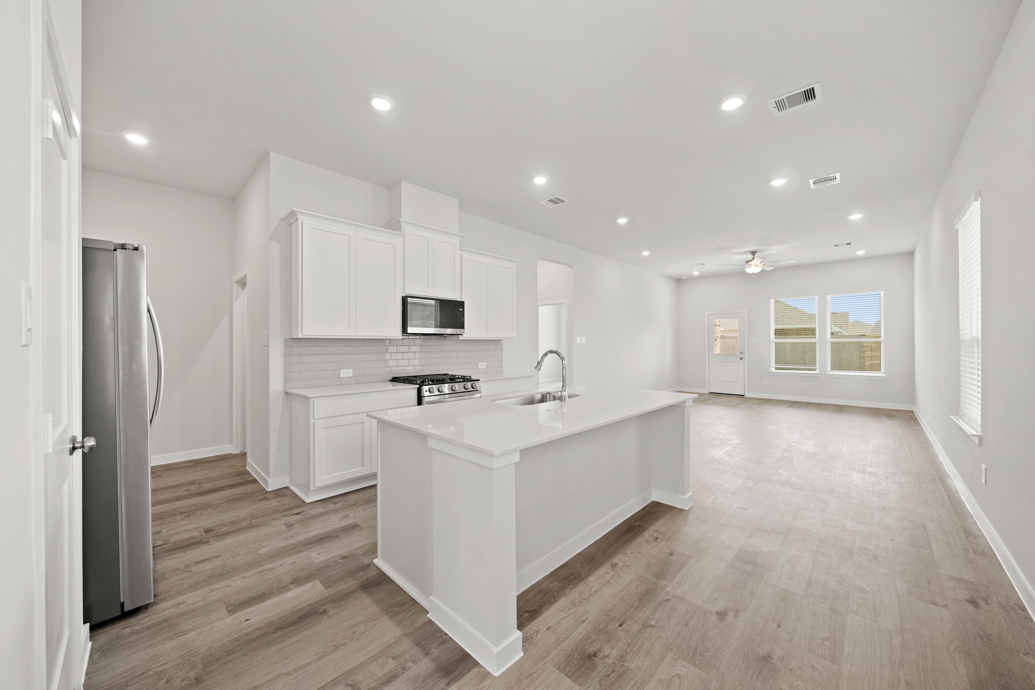A kitchen with white cabinets.