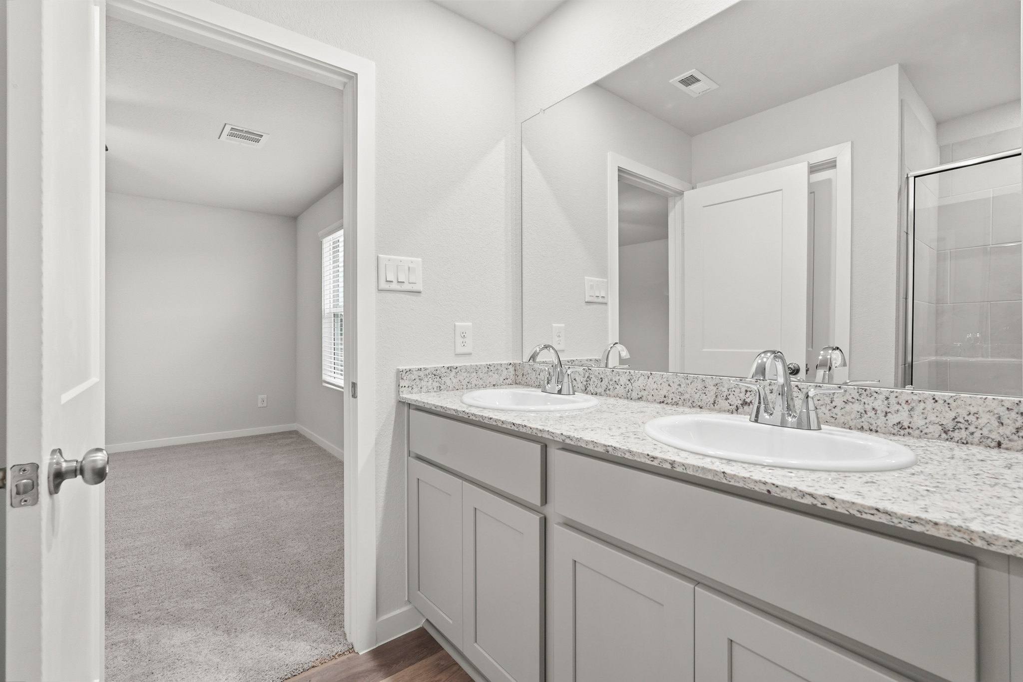 A bathroom with sinks and mirrors.