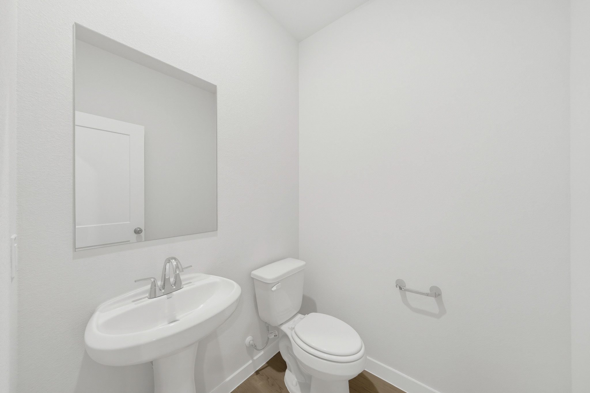 A bathroom with a toilet and sink.