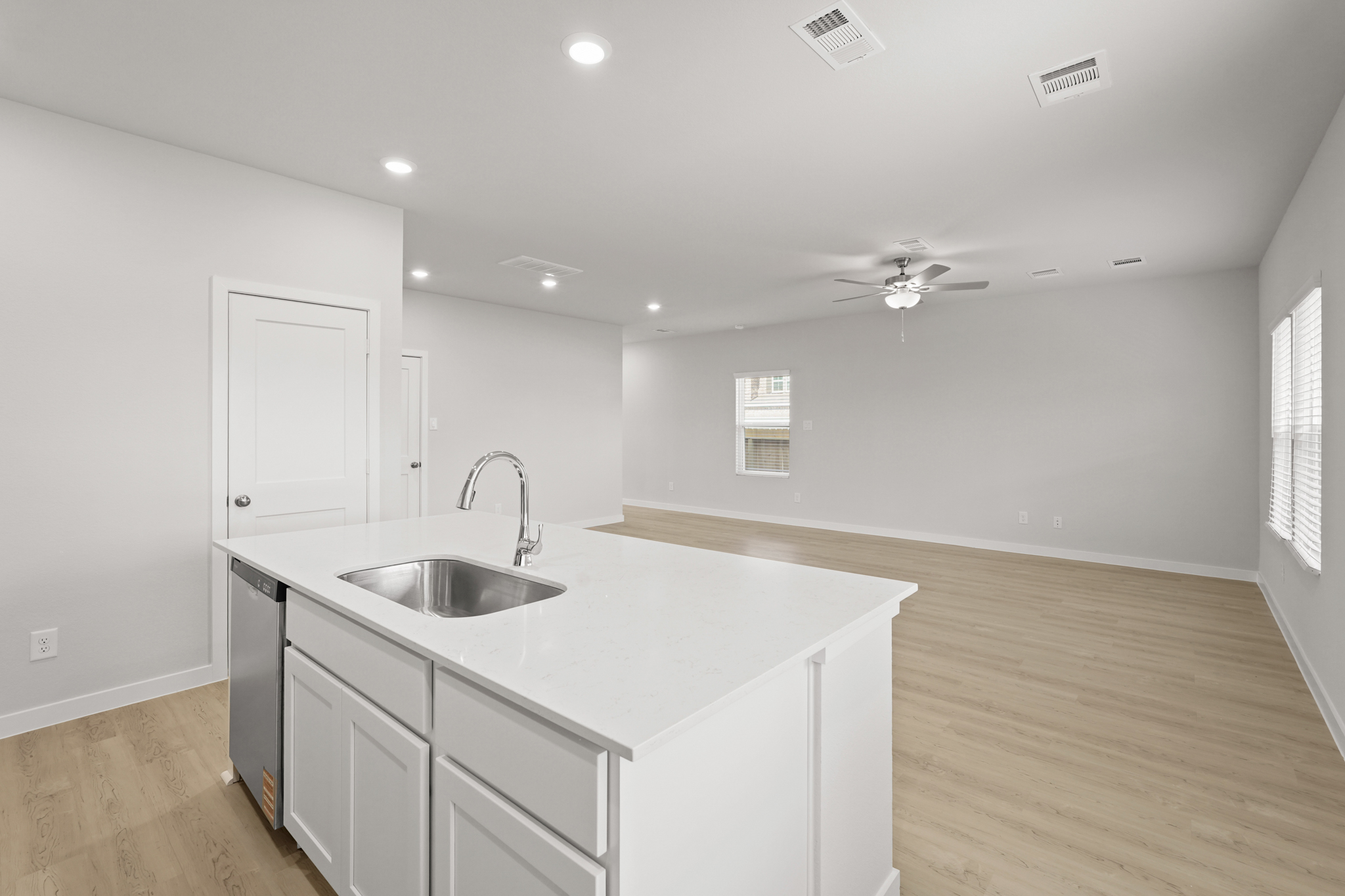A kitchen with white cabinets.