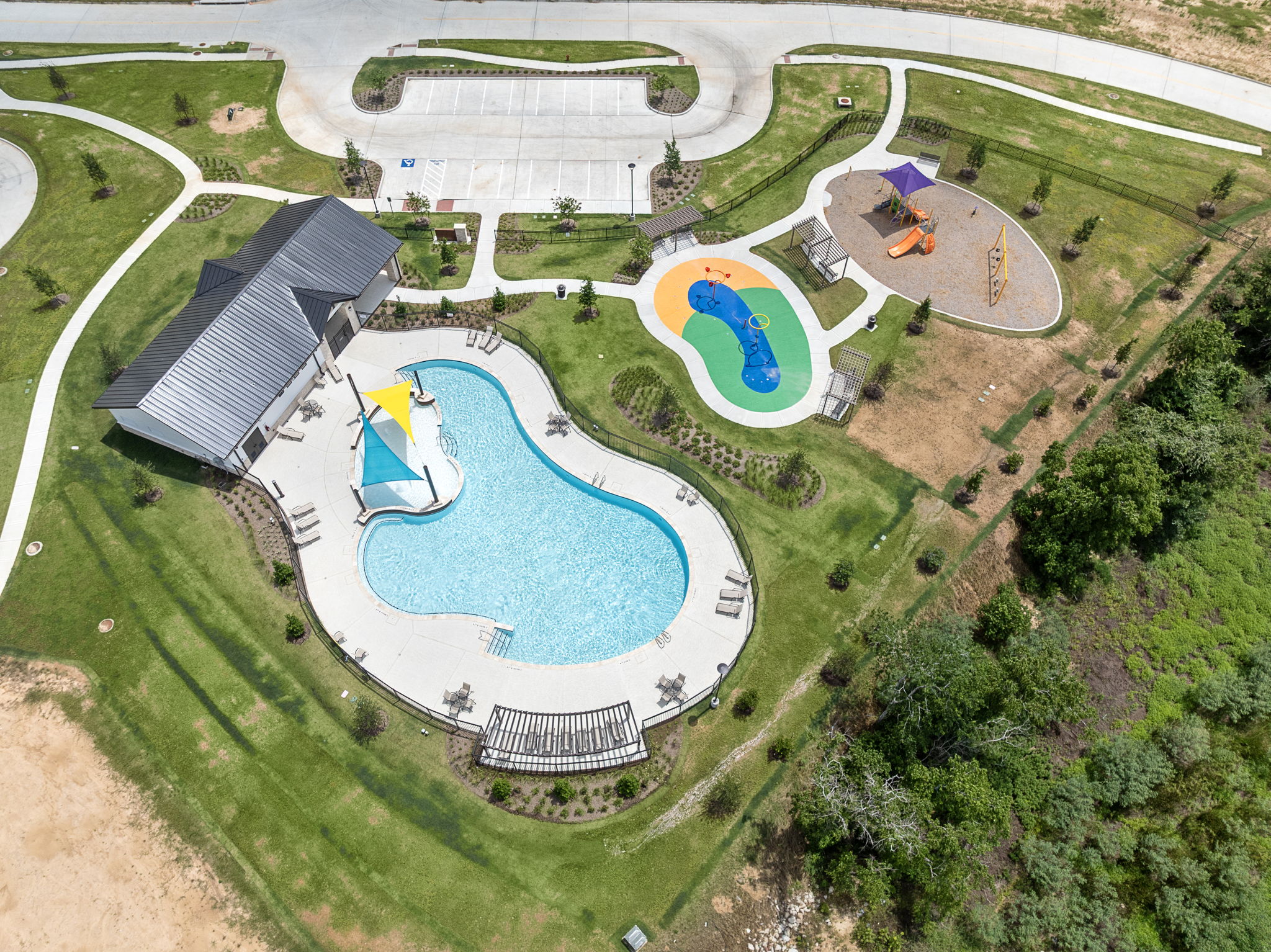 A building with a pool in the middle of a field.