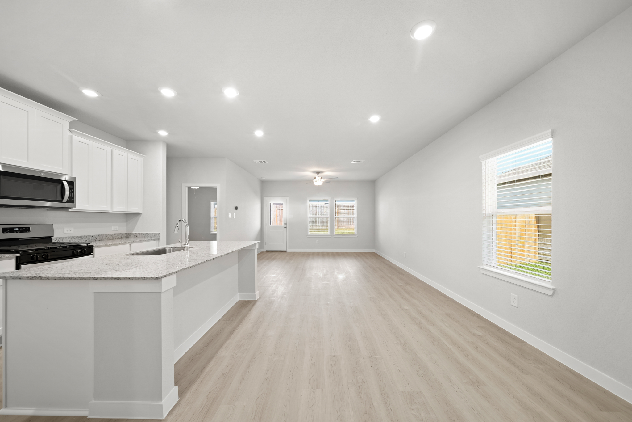 A kitchen with white cabinets.