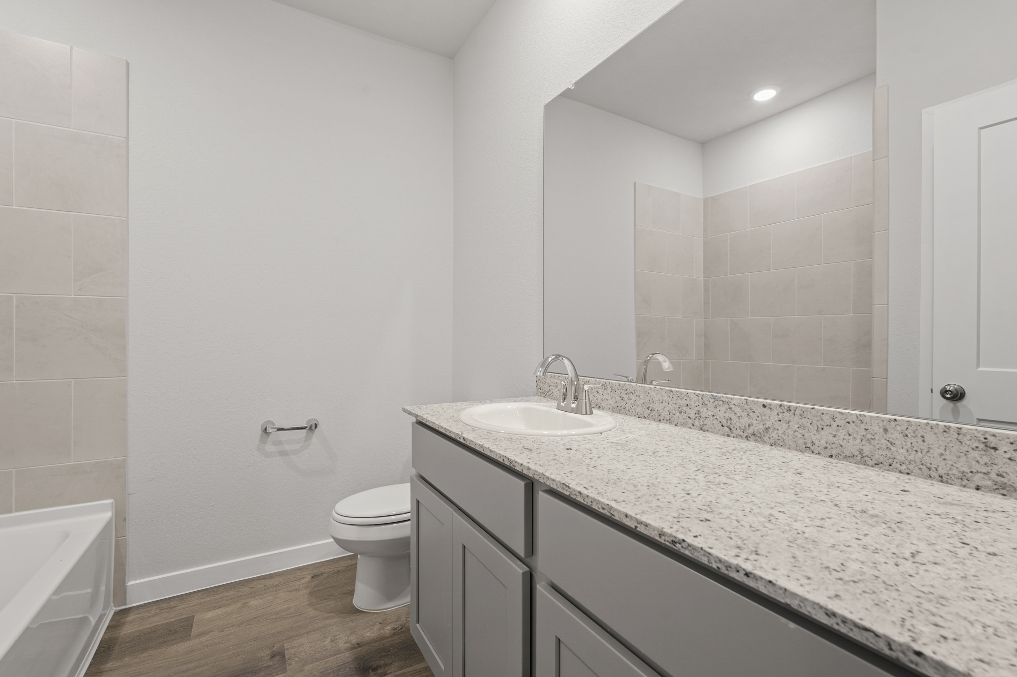 A bathroom with a marble countertop.