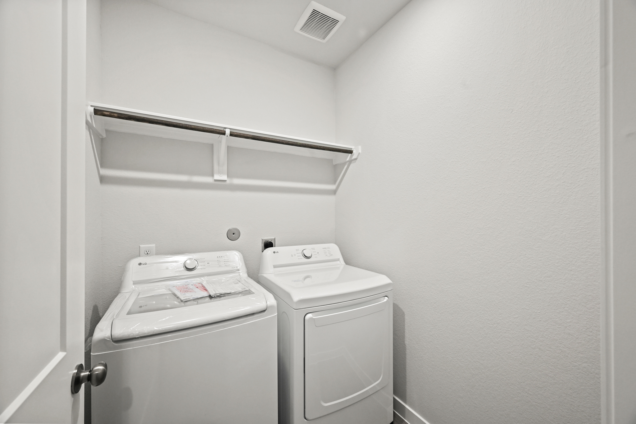 A white room with a washer and dryer.