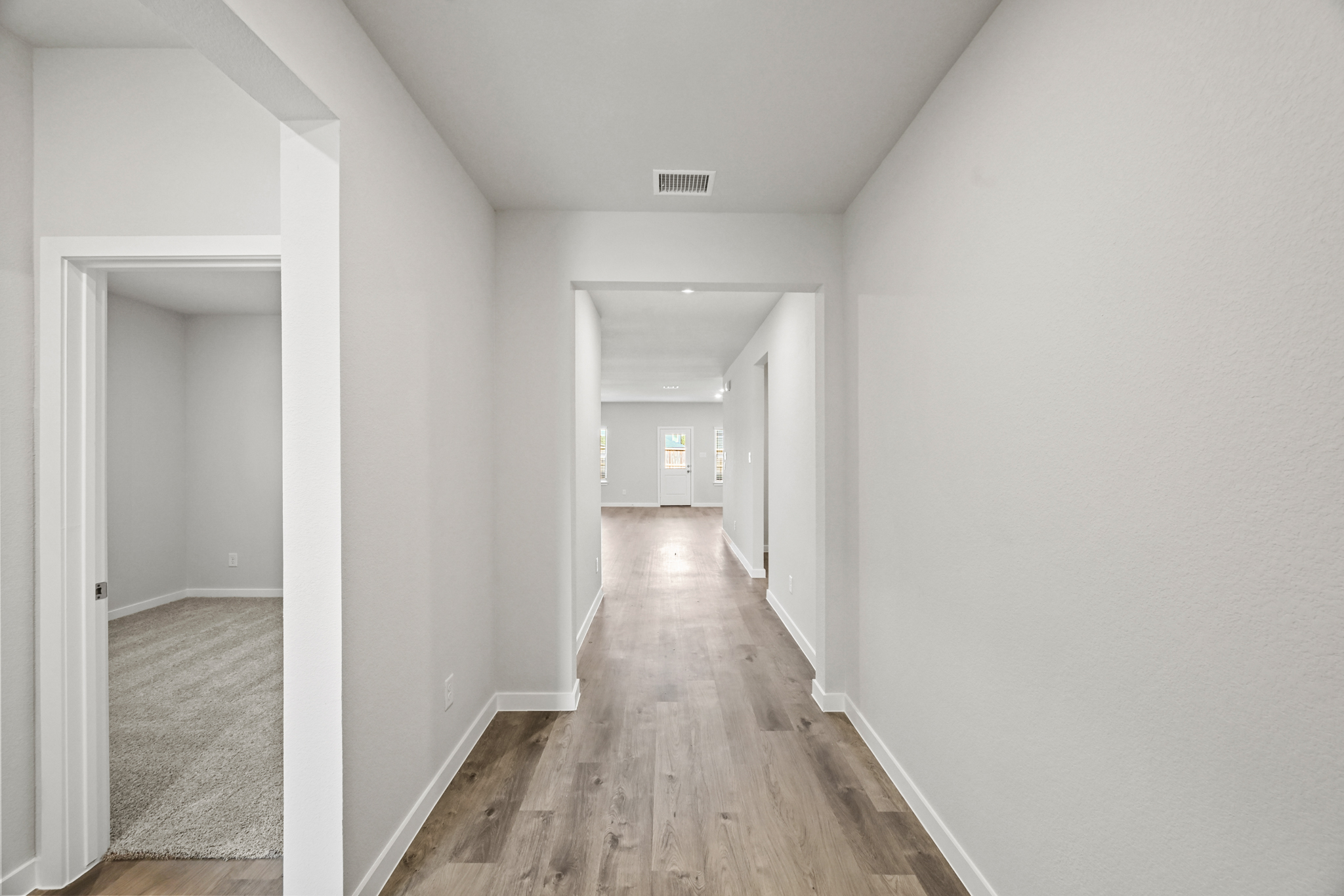 A long hallway with white walls.
