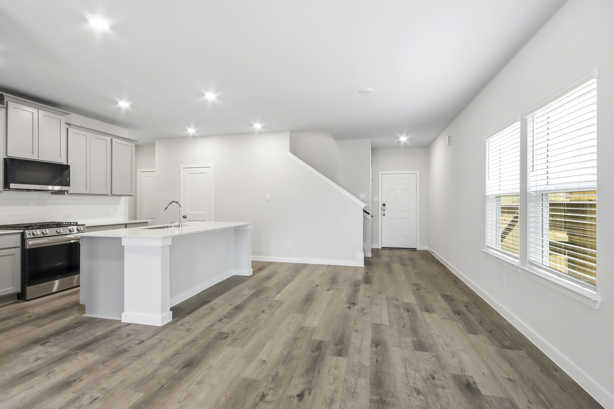 A kitchen with white cabinets.