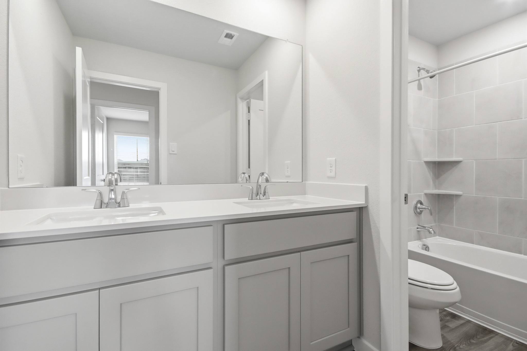 A bathroom with a tub sink and toilet.