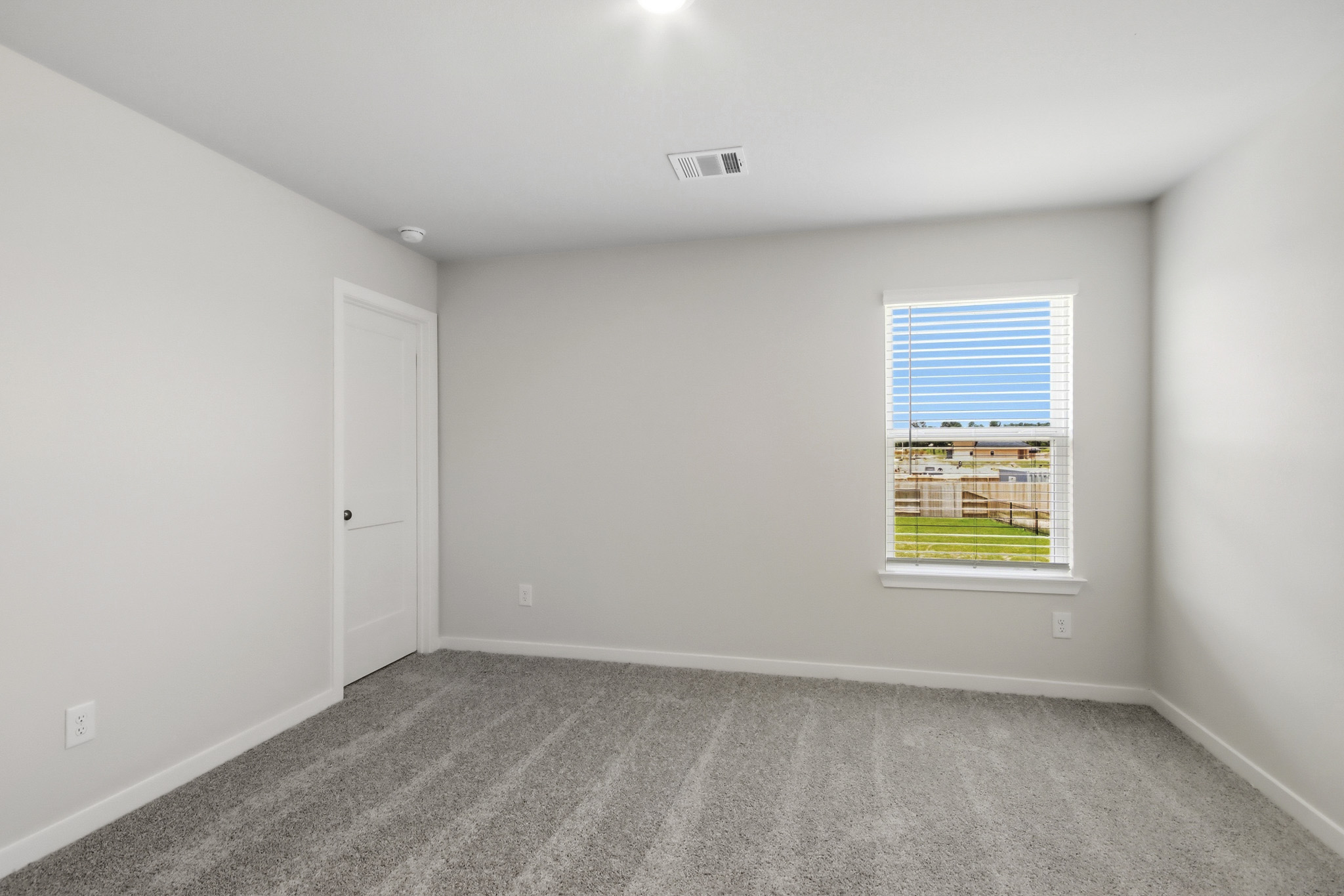 A room with a window and a door.