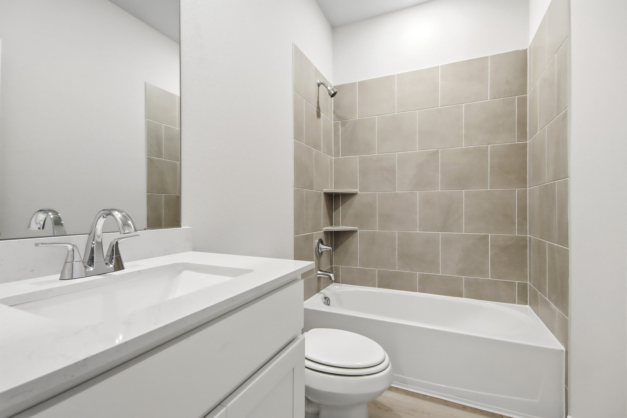 A bathroom with a tub sink and toilet.