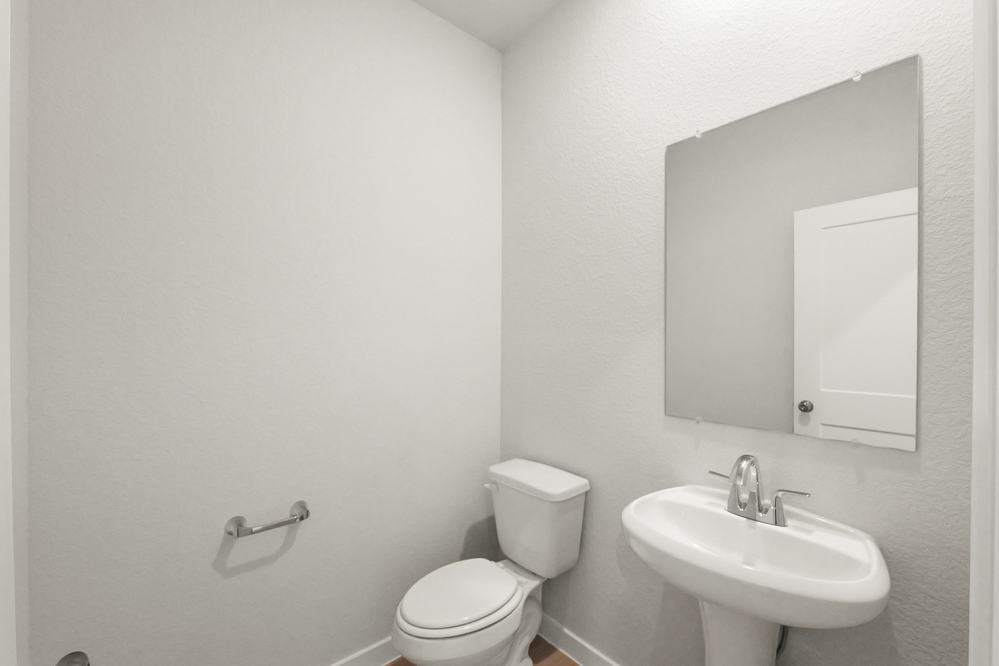 A bathroom with a toilet and sink.