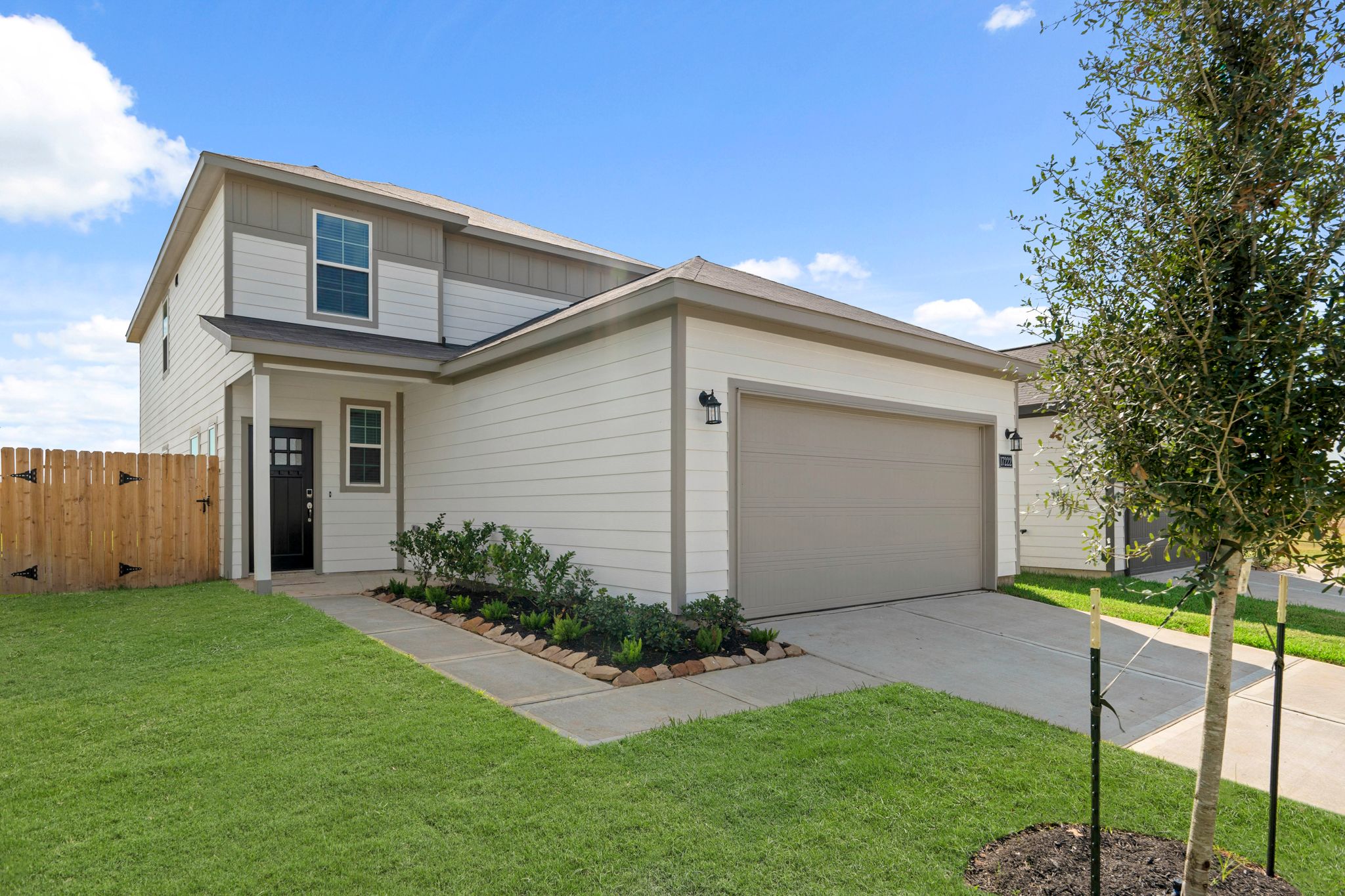 A house with a tree in the front yard.