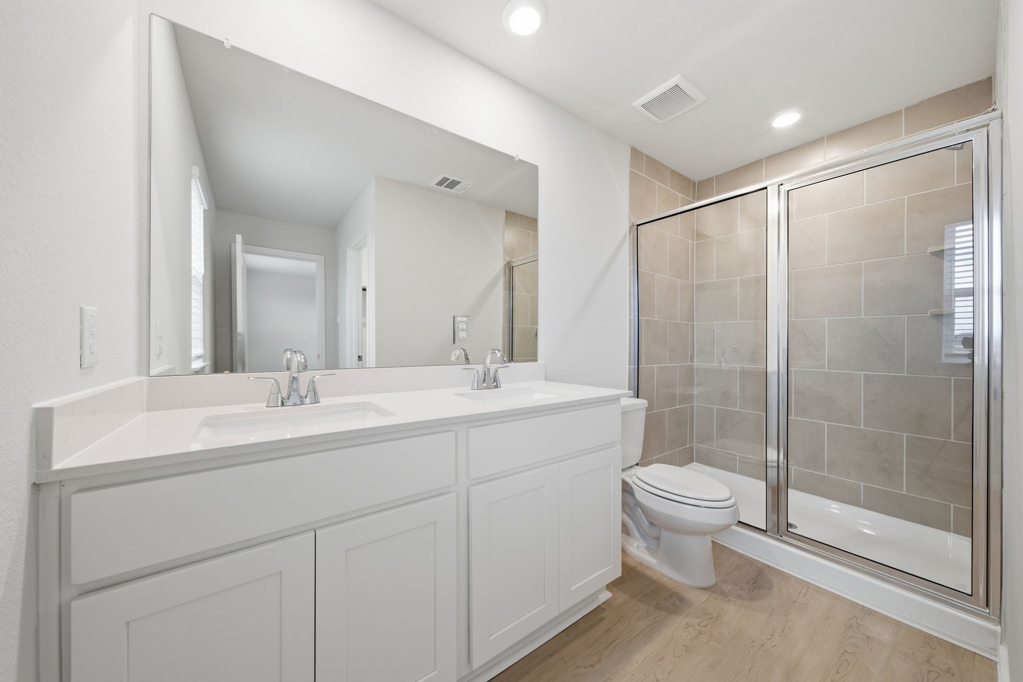A bathroom with a glass shower.