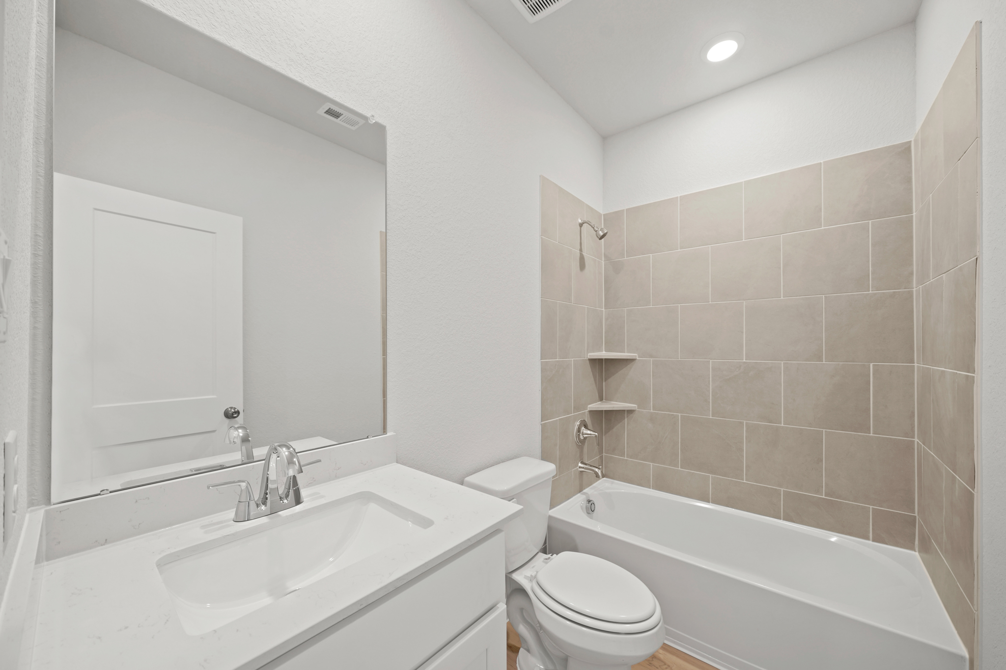 A bathroom with a tub sink and toilet.