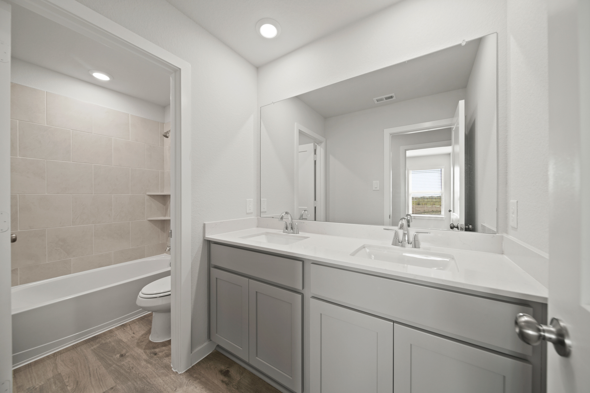 A bathroom with a tub sink and toilet.