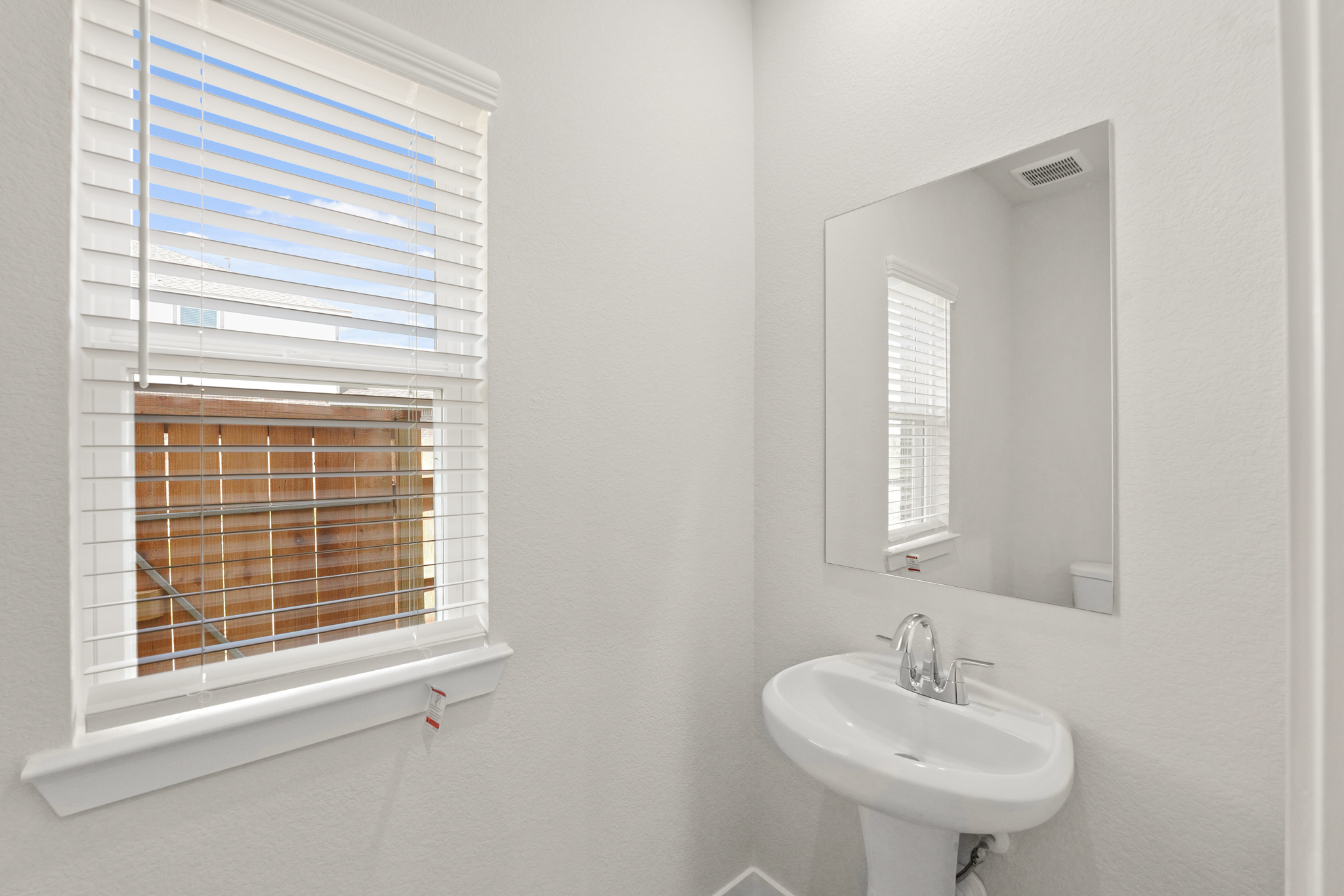 A bathroom with a sink and a mirror.