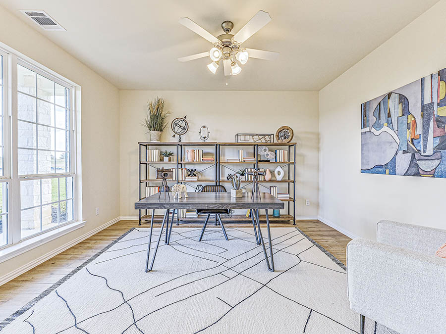 A living room with a table and chairs.