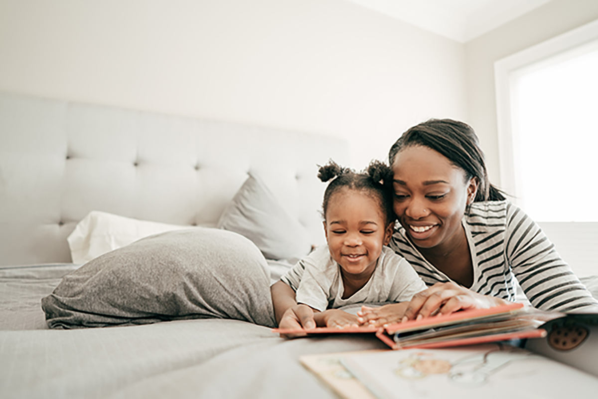 A woman and a child looking at a book.