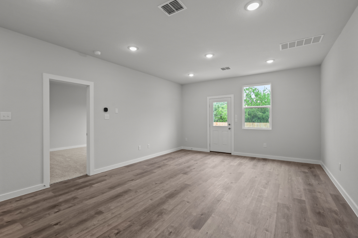 A room with a wood floor and a wood floor.