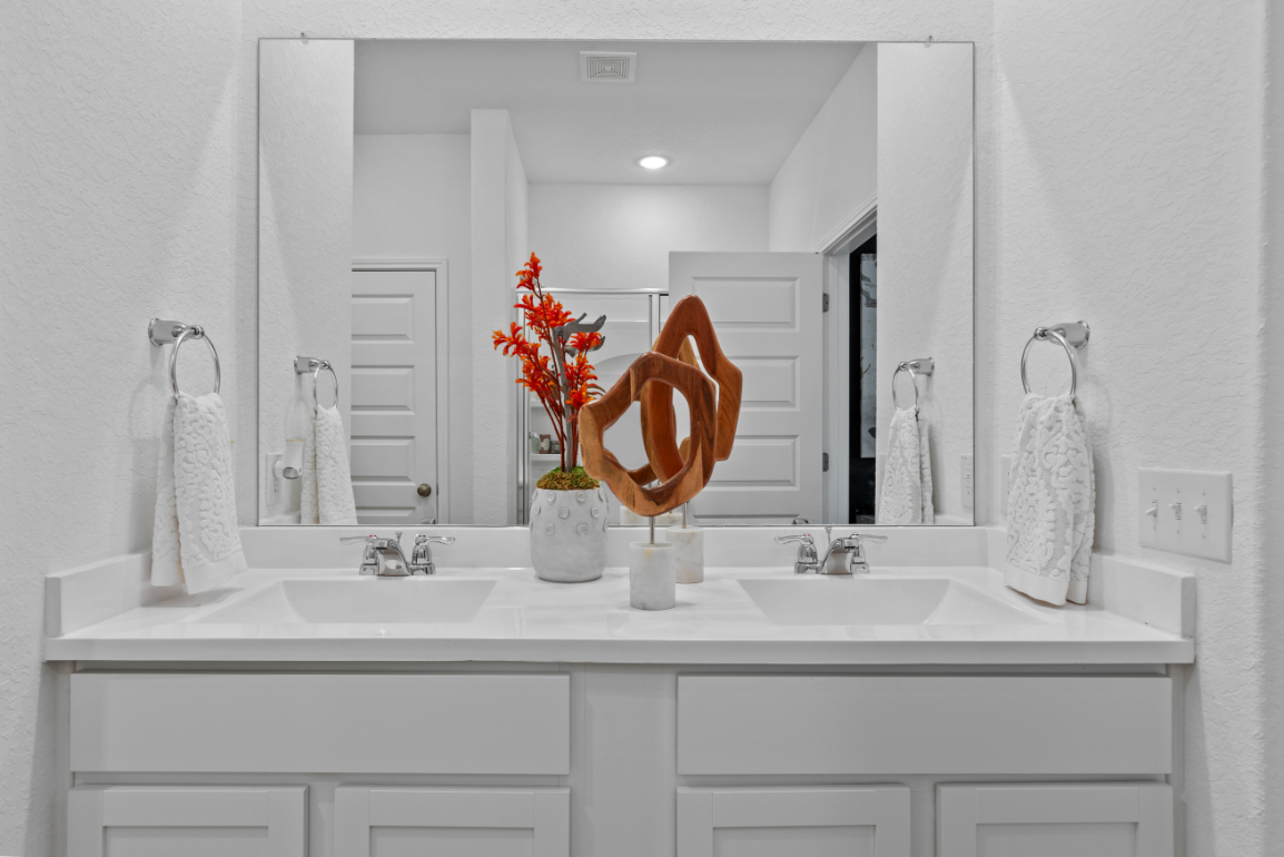 A bathroom with a large mirror.