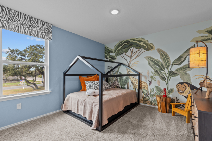 A bedroom with a bed and a lamp.