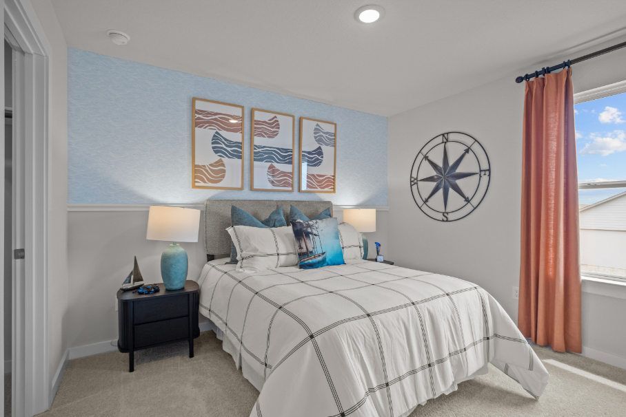 A bedroom with a bed and a lamp.